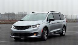 Car photo showing cluttered background with buildings.